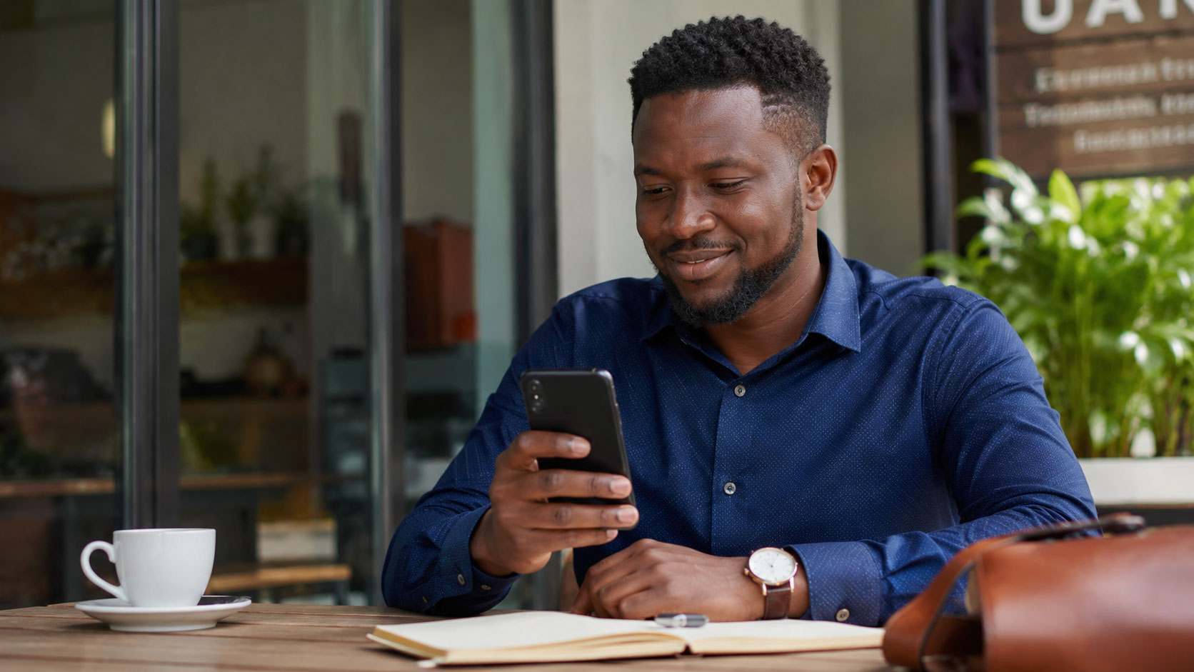 Business owner checking POS sales reports on a mobile phone