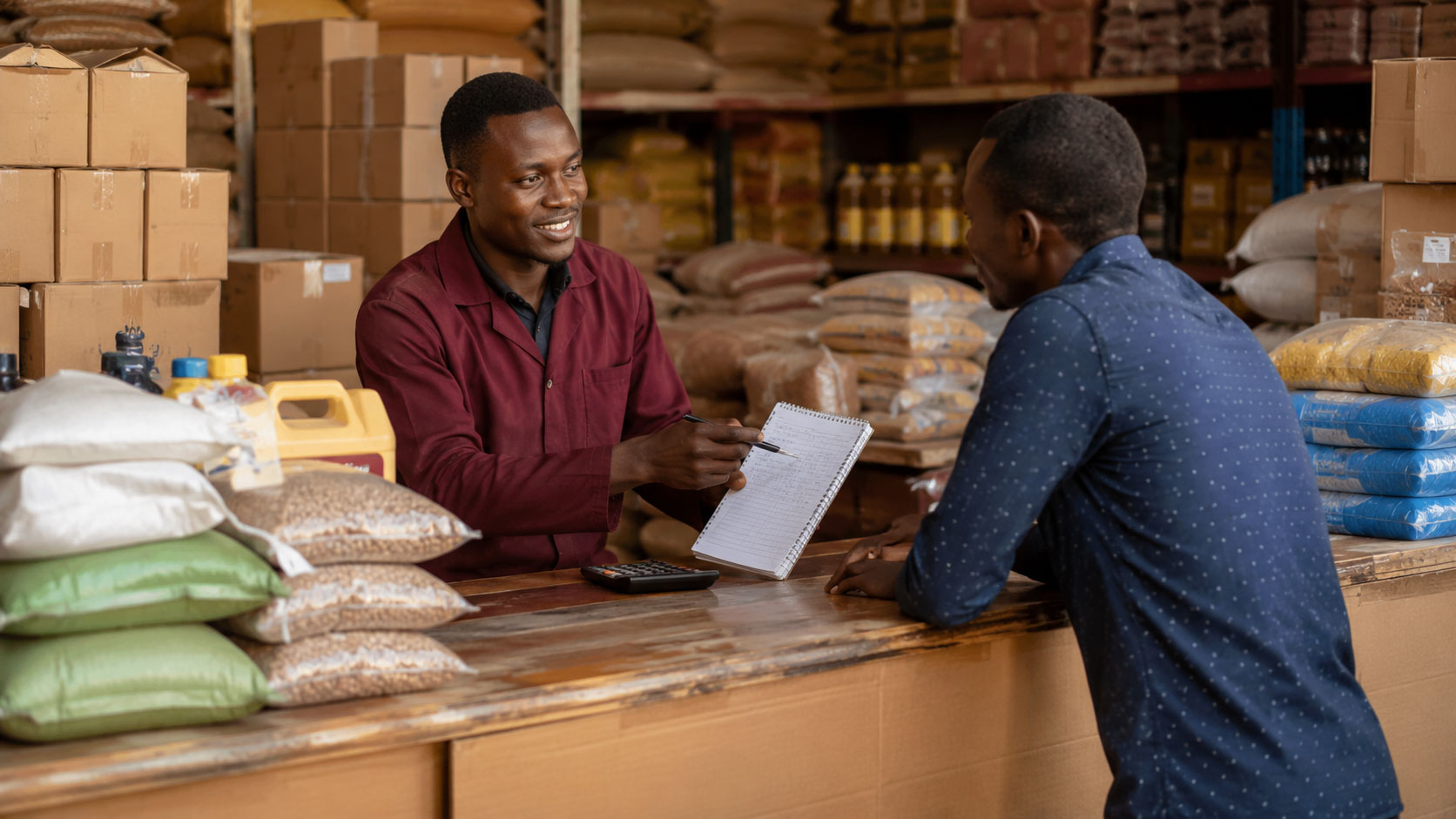 Wholesale customer buying goods while staff confirms pricing